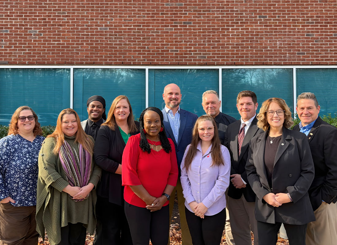 About Our Agency - Team Group Photo Outside Office Windows